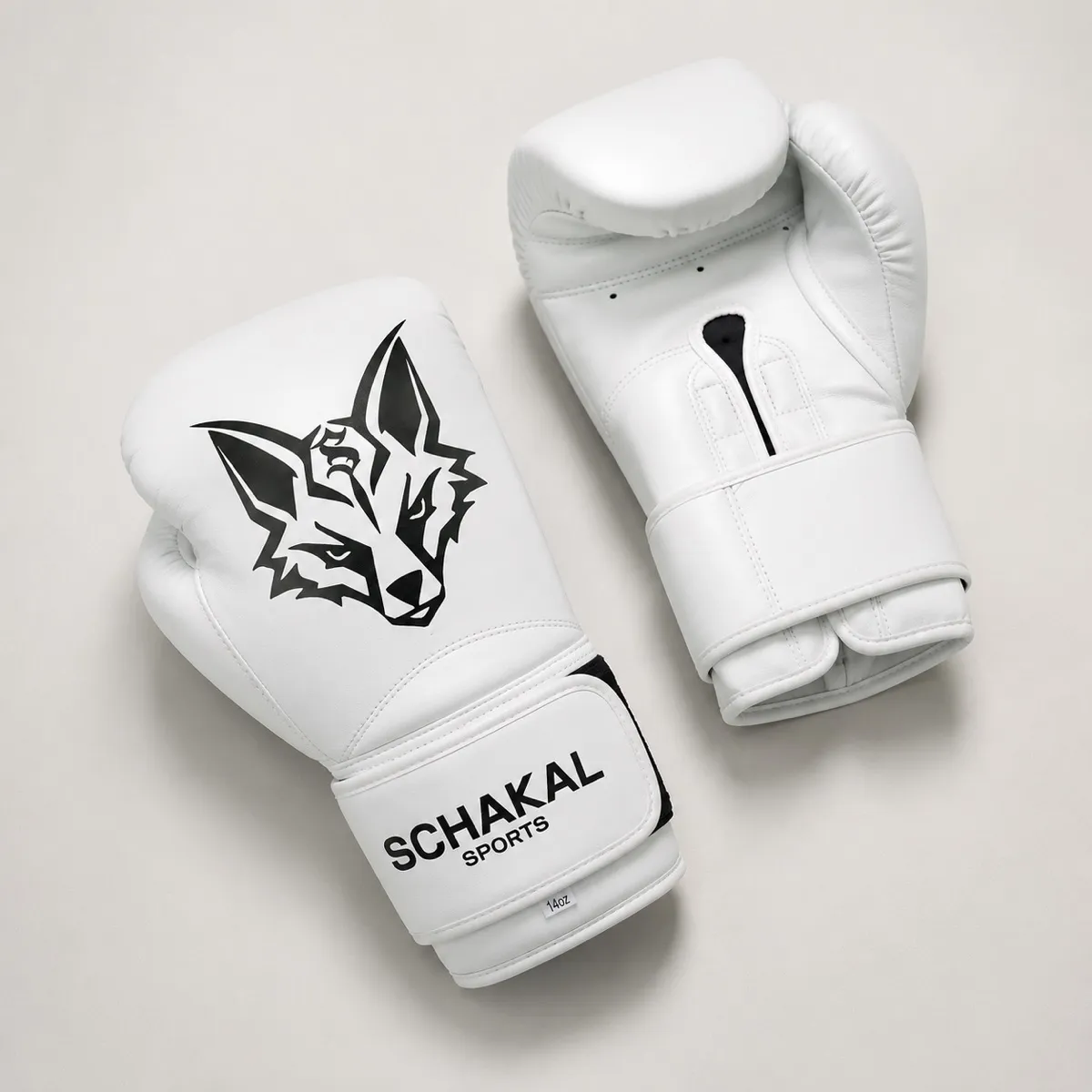 Weiße Schakal-Boxhandschuhe von oben auf hellem Grund, Schakalkopf und Innenseite nebeneinander